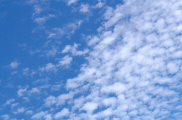 White cumulus clouds against  blue sky. Atmospheric phenomena.