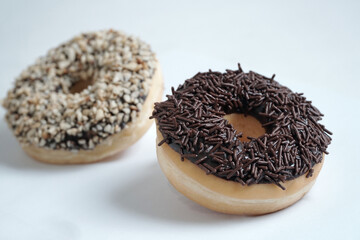 chocolate doughnut isolated on white background, with chocolate nut doghnut in background