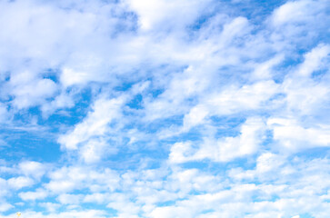 White cumulus clouds against  blue sky. Atmospheric phenomena.