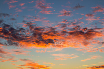 Beautiful sunset. Orange shades on clouds in  evening. Natural phenomena. Spectacular atmospheric effects.