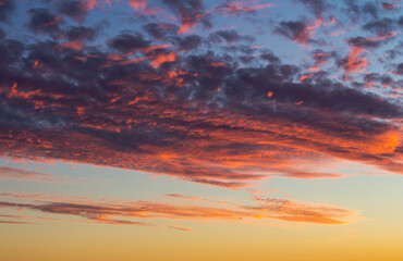 Beautiful sunset. Orange shades on clouds in  evening. Natural phenomena. Spectacular atmospheric effects.