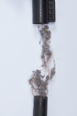 Dirt dust hair clogged in the vacuum cleaner tube