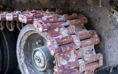 Rusty broken tracks with track rollers of a wrecked tank. Russian battle tank destroyed during the fighting during the Russian invasion of Ukraine, 2022. Remains of Russian military equipment.