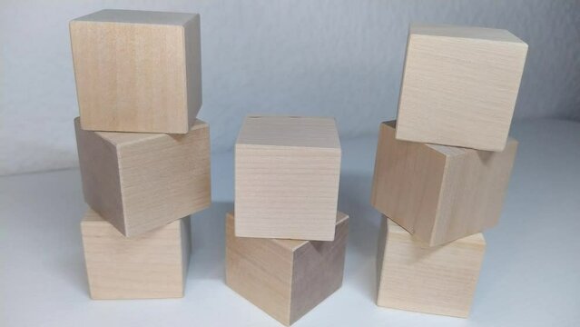 Mathematical count for subtraction 9-1=8 A person dismantles a structure from wooden blocks, removes the blocks manually.