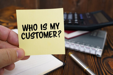 In the hands of a man is a sticker with the inscription - Who is My Customer