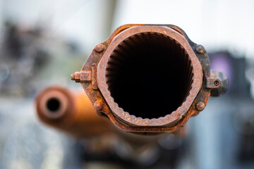 Tank gun, barrel muzzle of a military army close-up. Broken burnt tank. Barrel of a tank gun,...