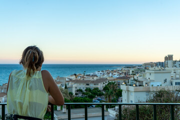Fototapeta na wymiar Girl enjoying sunset over sea in Torremolinos, Spain on September 04, 2022