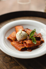 Appetizing Italian pasta with cheese on a dark wooden background