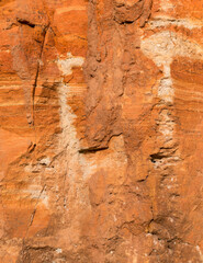 Sedimentary rocks with a high content of iron oxide. Red soil, loam. The texture of the soil.