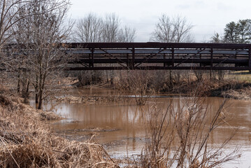 A Metal Trail Bridge Across The River