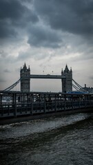 Vertical shot of the tower bridge under a gloomy sky in London, UK