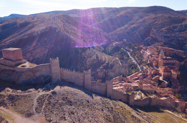 Aerial view of tiled housetops and defensive wall of medieval town Albarracin, Spain