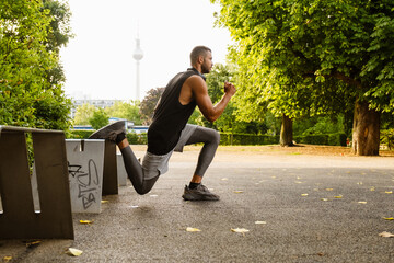 Young white athlete man in sportswear doing workout in park