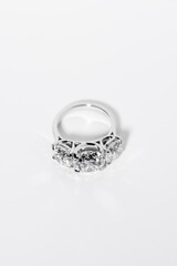 Beautiful diamond ring on a white background - concept of wedding and engagement