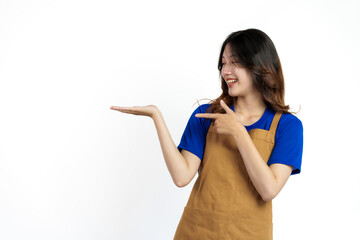 Palm up, Cheerful young pretty asian woman blue t-shirt and apron coffee owner isolated on white background.