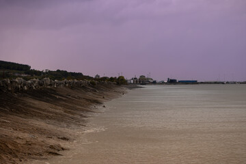 Mostyn Docks beach with moody sky