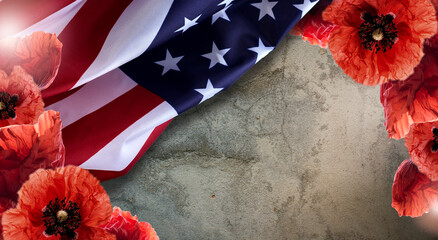 Remembrance day banner with red poppy flowers against the rough background. Memorial for victims of...