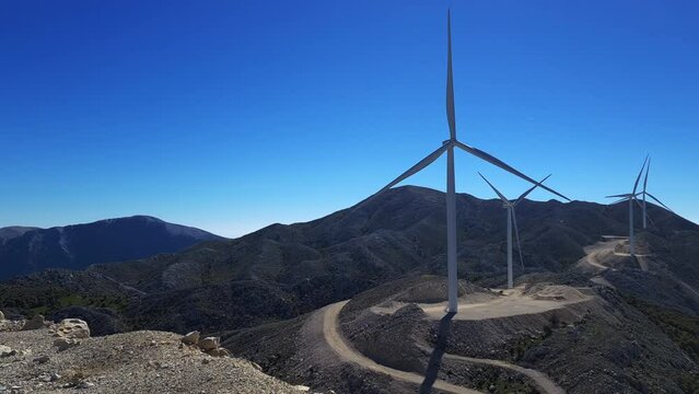 A wind farm situated on a mountain top. Pan shot showing the breath taking views.
