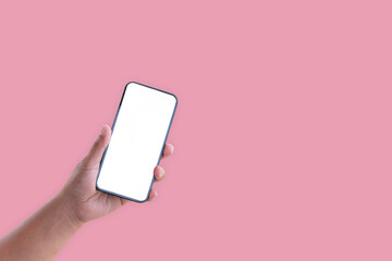 Hand holding smartphone with blank screen isolated on pastel pink color background with clipping path. ideas design business concept.