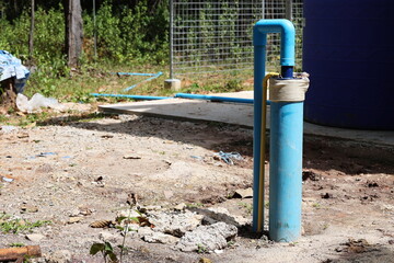 PVC pipes of underground wells. Rural artesian well with photovoltaic powered submersible pump on...