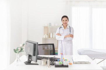 smart female doctor do work in hospital, she stand up and cross arm, she feeling happy in relax time, she ready to service and treatment patient