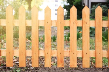 Closeup view of wooden fence outdoors on sunny day