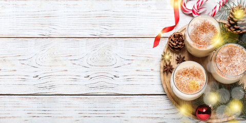 Delicious Christmas cocktail with liqueur on white wooden table, flat lay with space for text. Banner design