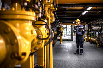 Refinery worker engineer controlling crude oil production inside factory.