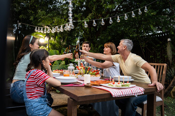 Multi-ethnic big family having fun, enjoy party outdoors in the garden.