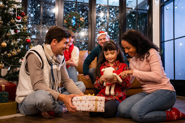 Caucasian family exchanging presents during Christmas party at home. 