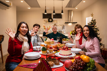 Multi-ethnic big family celebrating Christmas party together in house.