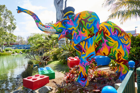Neon colored elephant made of legos in a theme park in Southern California USA