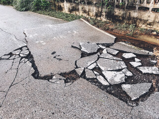 decayed road paved asphalt distressed road surface with damaged, peeling damaged road waiting for...
