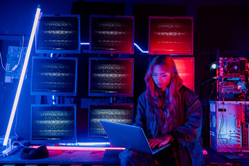 Program or cyber security development concept. Young woman working with monitors and checking...