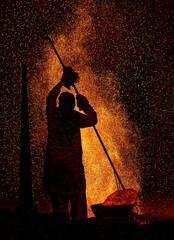 silhouette of a kiln worker