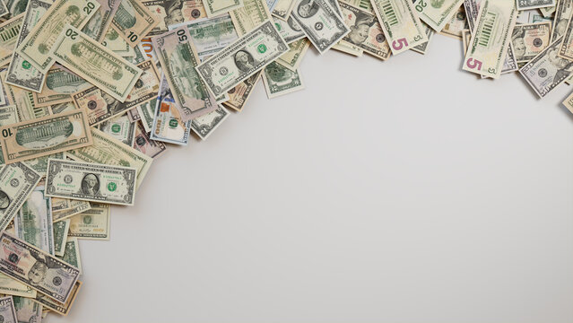 Mixed Denomination Bills Border on White Surface. Banking Background with copy-space.