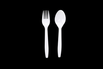 White plastic spoon and fork isolated on black background with clipping path.
