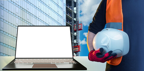 Construction technologies. Laptop for advertising architectural companies. Protective helmet in...