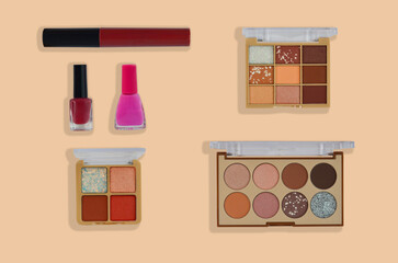 set of decorative cosmetics, pastel and nude eye shadow colors, 
lip gloss and nail polish for woman make up