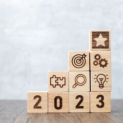2023 wood block with business success, goal, strategy, target, mission, action, objective,...