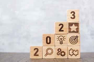 2023 wood block with business success, goal, strategy, target, mission, action, objective, teamwork, plan, idea and New Year start concept