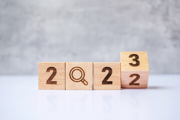 flip 2022 to 2023 block with magnifying glass icon. SEO, Search Engine Optimization, hiring,...