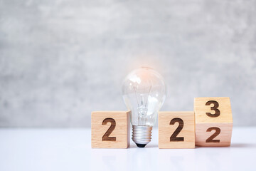 flip 2022 to 2023 block with lightbulb. Business Idea, Creative, Thinking, brainstorm, Goal, Resolution, strategy, plan, Action, change and New Year start concepts