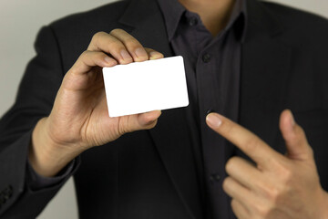 A businessman holding white mock up ID card design
