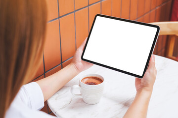 Mockup image of a woman holding digital tablet with blank white desktop screen in cafe