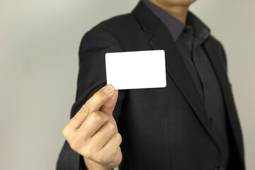 Business Man holding white ID card, A smart man holding white mock up inter card, used for poster...