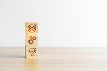 dartboard above Gear and Lightbulb icon block on desk. business planning process, goal, strategy,...