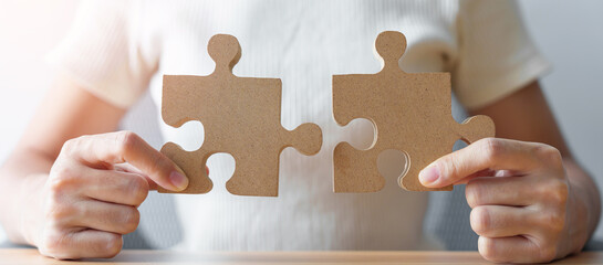 Hand connecting couple puzzle piece. Business Solving, mission, challenge, success, goals, target...