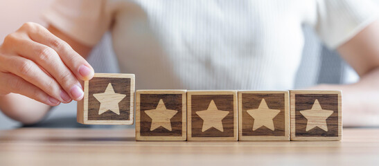 hand holding Star block. Customer choose rating for user reviews. Quality, Service rating, ranking,...