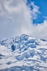 vertical view of the snow-capped mountain from afar